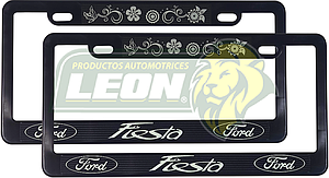 PORTAPLACAS NEGRAS GRABADAS FORD FIESTA / FLORES LETRAS FLUORESCENTES (JGO. c/2 pzas.)